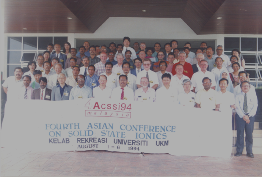 A group of people holding a banner
Description automatically generated